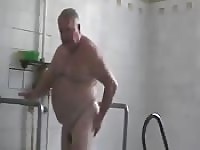 Fat grandpa taking a shower and being taped